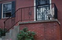 PICKET RAILING ON ENTRANCE PORCH WITH SCROLL DESIGN