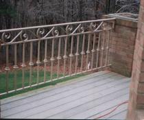 PICKET RAILING WITH SCROLL TOP DESIGN AND COLLARS ON WOOD DECK